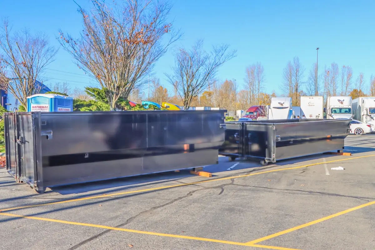 Professional dumpster rental service with roll-off container on residential driveway in Bessemer City